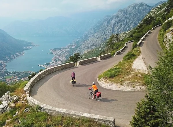 Cyclists riding the switchbacks above the Bay of Kotor
